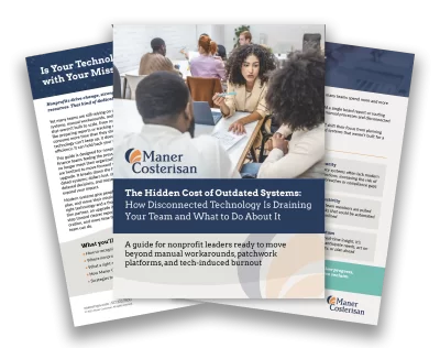 A brochure titled The Hidden Cost of Outdated Systems: How Disconnected Technology Is Draining Your Team and What to Do About It by Maner Costerisan, featuring a group of people collaborating in a modern office.